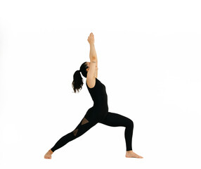 Woman doing yoga asana in white background. Black outfit. Ashtanga, Vinyasa, Hatha