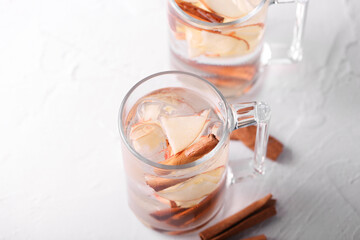 detox drink with apple cinnamon and ice stands on a light background in glass glasses