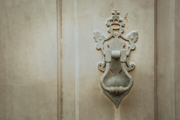 Fototapeta na wymiar Brass door knocker of doors of the historic city of Paraty, Brazil, founded in 1667.