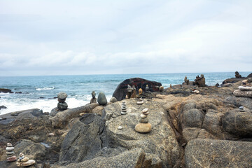 Pile of stones on rocks on the beach. Concept of calm, relaxation. 