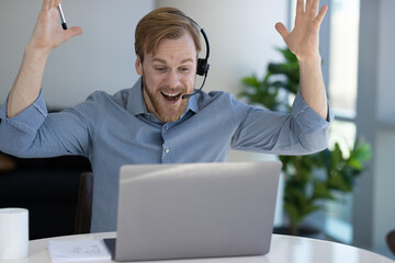 Caucasian man at home remote working on laptop computer talking with his colleague