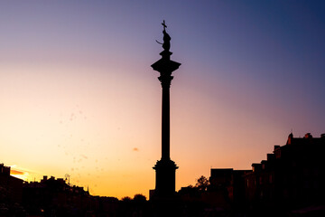 Fototapeta na wymiar Sigismunds Column silhouette at sunset erected in 1643 and designed by Constantino Tencalla and Clemente Molli at Castle Square - Warsaw, Poland