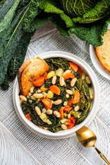 Tuscan bread soup made with toasted bread and vegetables. Ribollita. Cannellini beans, lacinato...