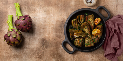 Artichoke or carciofi vegetable, raw and cooked. Artichokes boiled and roasted in olive oil with...