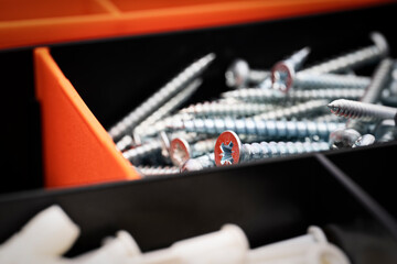 Close up of pile of metal screws in a toolbox