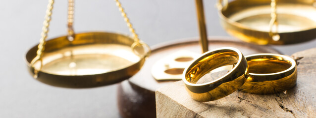 Divorce and separation concept. Two golden wedding rings, judge gavel. - 485406852