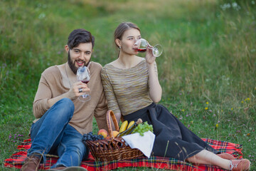 young couple drinking wine in nature