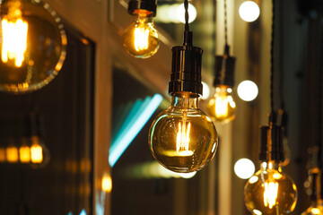 Beautiful and cosy luxury light lamps. Cosy cafe, coffee shop or lounge interior. Vintage, many different vintage light bulbs hanging from ceiling