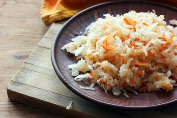 sauerkraut in a clay bowl. homemade food obtained from cabbage.
