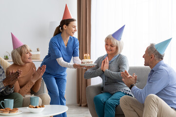 Birthday party at nursing home, senior people celebrating birthday