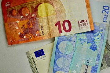 Many different euro bills spread randomly over a surface