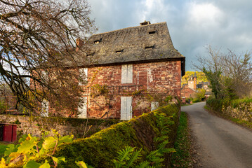 Fototapeta premium A red stone traditional building in Correze, France