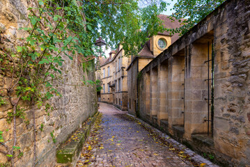The narrow street of a beautiful french yellow stone medieval town of Perigord