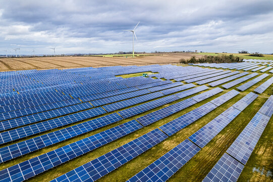 Aerial shot of Large solar farm and wind turbine, UK