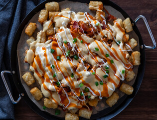 A platter of buffalo chicken tater tot nachos fresh out of the oven