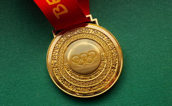 January 27, 2022, Beijing, China. XXIV Olympic Winter Games gold medal on a green background.