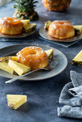 Servings of mini pineapple upside down cakes, ready for eating.