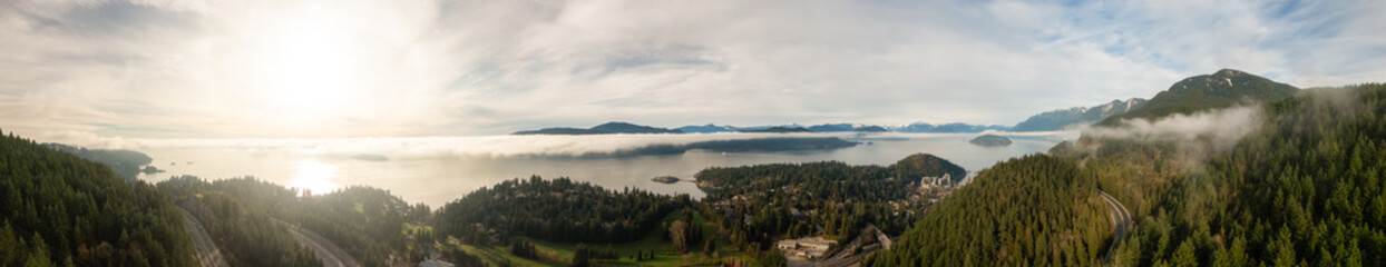 Aerial panoramic view of Horseshoe Bay during a sunny winter evening before sunset. Taken in West Vancouver, British Columbia, Canada.