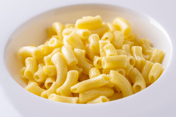 spaghetti on a white plate and a white table