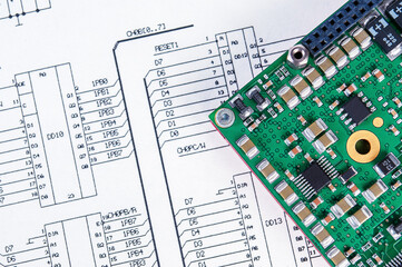 Electronic board on background of  schematic circuit diagram. Concept for development and design of...