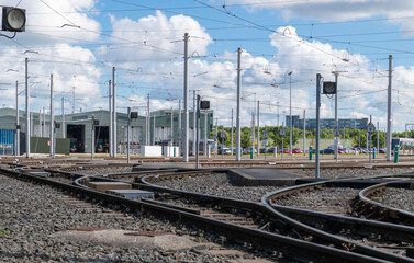 Fototapeta na wymiar Rail junction in a deppot of trams. Crossing railroad tracks with switches and traffic lights.