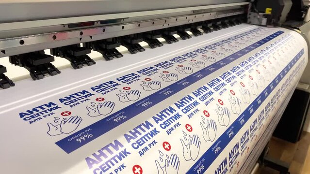 The printing press prints stickers for antiseptics. Large-format advertising printing.