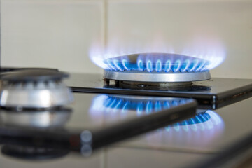 Blue gas flame on a stove hob, selective focus