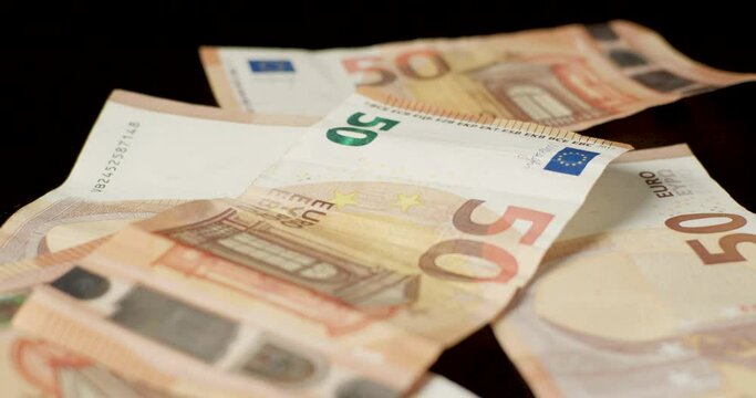 Billetes de euros cayendo sobre la mesa a c&aacute;mara lenta. Dinero en efectivo y ganancias.