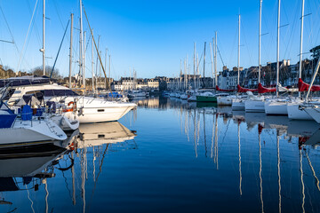 Vannes, beautiful city in Brittany, boats in the harbor, with the cathedral in background 

