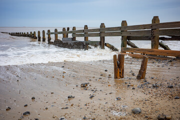 Wooden groynes to protect the fragile cliffs from coastal erosion on Cromer beach