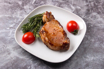 Fried pork steak on a plate. Serving meat