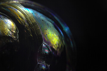 Soap bubbles with colored patterns on the surface in macro. Details and reflections on the soap bubbles in close-up.