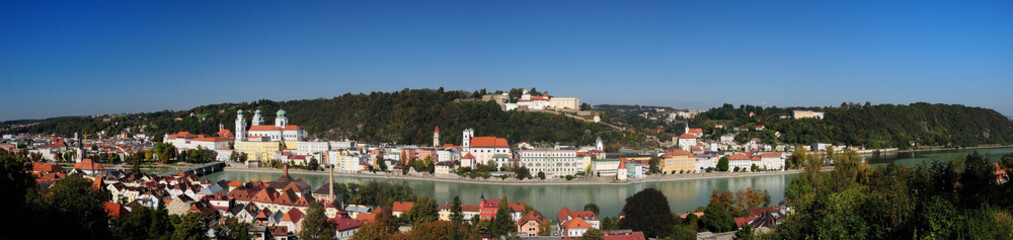 Fototapeta na wymiar Panorma View From The River Inn To The Old City Of Passau And Fort Veste Oberhaus Germany On A Beautiful Sunny Summer Day With A Clear Blue Sky And A Few Clouds