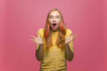 Wow emotion. Amazed young girl open mouth make big eyes surprised by online store offer, discounts on pink background