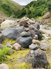 Pyramid of stones on the backdrop of mountains in the Elbrus region. Balance, meditation and stability concept