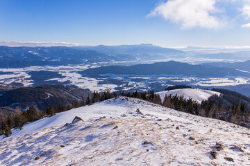 Fototapeta na wymiar Idyllic winter landscape in the Seckauer Alpen in Austria view a view over the Aichfeld with Seckau and Knittelfeld in the valley