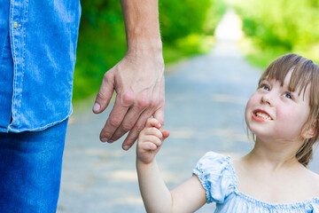 A Hands of happy parent and child on nature on the road in park background