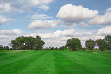 Fototapeta na wymiar landscape. golf course and sky with clouds. lawn grass.