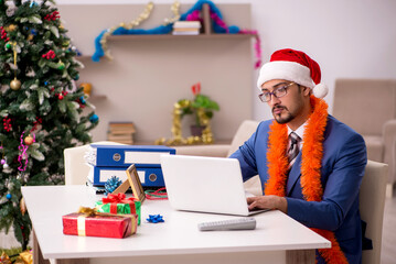 Young businessman working from home at Christmas eve