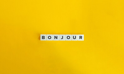Bonjour word on letter tiles on yellow background. Minimal aesthetics. © photoopus