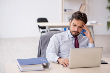 Young male employee working in the office