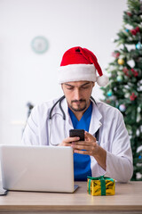 Young male doctor celebrating Christmas at the hospital