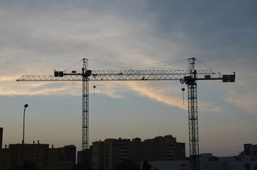 Fototapeta na wymiar Construction machine. Construction Crane on a background of the sky. building. Industrial construction cranes and building silhouettes 