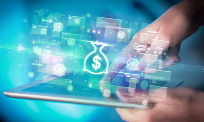 Close-up of a hand using tablet, currency concept