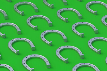 Row of silver horseshoes on a green background. Symbol of luck. 3d render