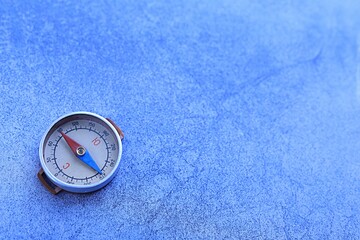 old compass on a blue cracked background