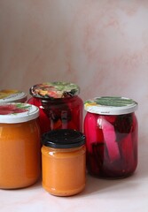 jars with homemade preserves, silage in jars, kohlrabi and marinated beetroot, marinated radish, healthy vegetables, chopped vegetables and flooded with brine, apricot jams