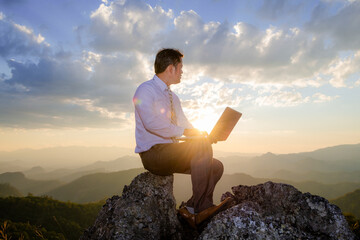 Naklejka na ściany i meble business man working outdoors wirelessly with laptop