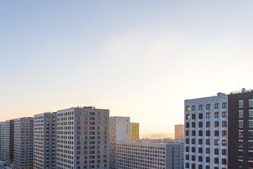 urban modern landscape: multi-colored new buildings residential buildings, facades, sunset