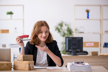 Young woman working in box delivery service